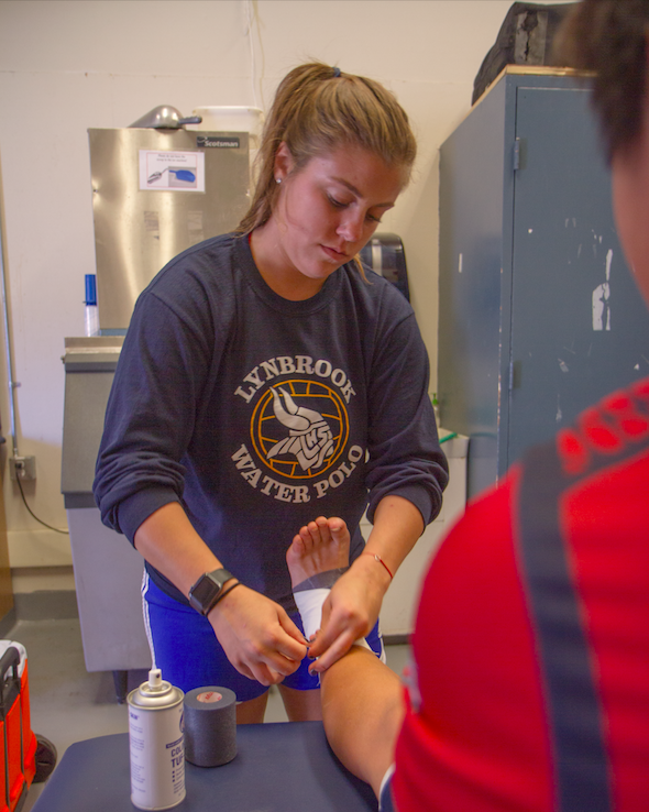 Athletic trainer helps players back on their feet