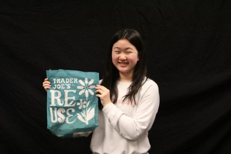 Writer Aileen Xue holds up a bag from Trader Joes.