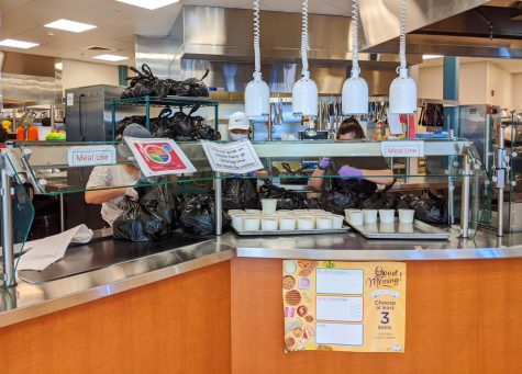 Workers bag meals at the Cupertino High School cafeteria.