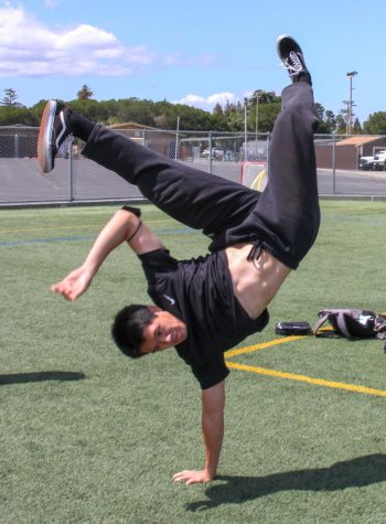 Senior Andrew Chang powerfully kicks his legs in a break dance move. 