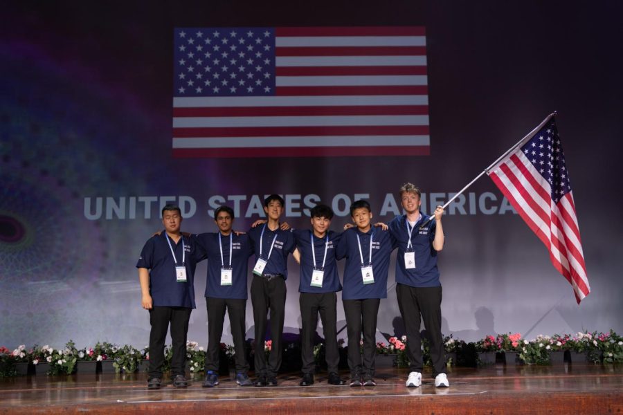Shen wins a gold medal at the International Math Olympiad with a score of 36 points out of 42.