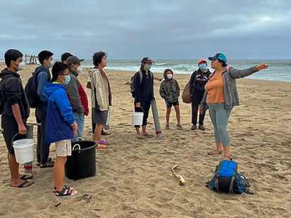Marine Wildlife Club members extract samples using sand cores and analyze mole crabs at Pescadero Beach with the guidance of Schneider. Used with permission from Vivian Frazita. 
