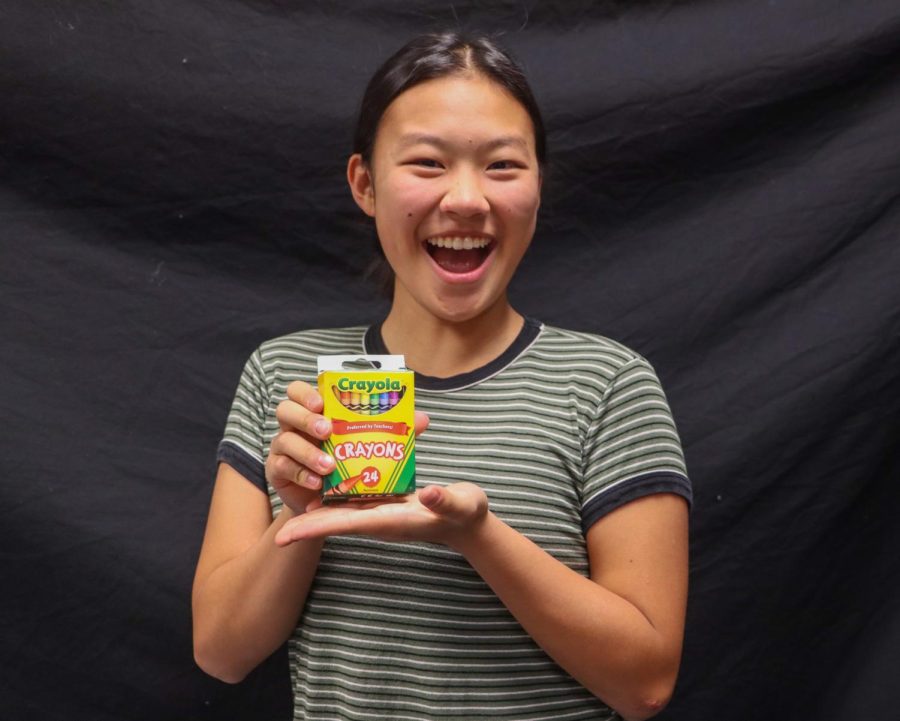 Elizabeth Cheng poses with crayons, showing her love for art. 