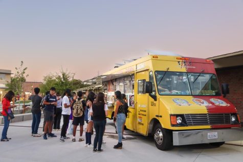 Students line up to get food from the 3-3-3 fusion food truck. 