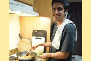 Aarush cooking with a smile, pan still sizzling. 