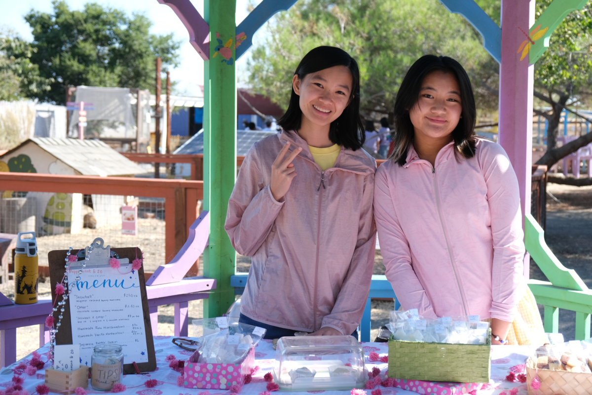 Mak and Lim in front of their booth proudly displaying their creations. Used with permission from Zoey Lim