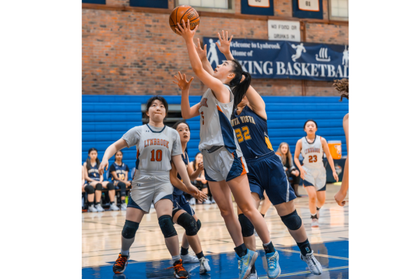 Senior Maggie Lam shoots a layup during a home game against Monta Vista High School. Used with permission from Austin Wu.