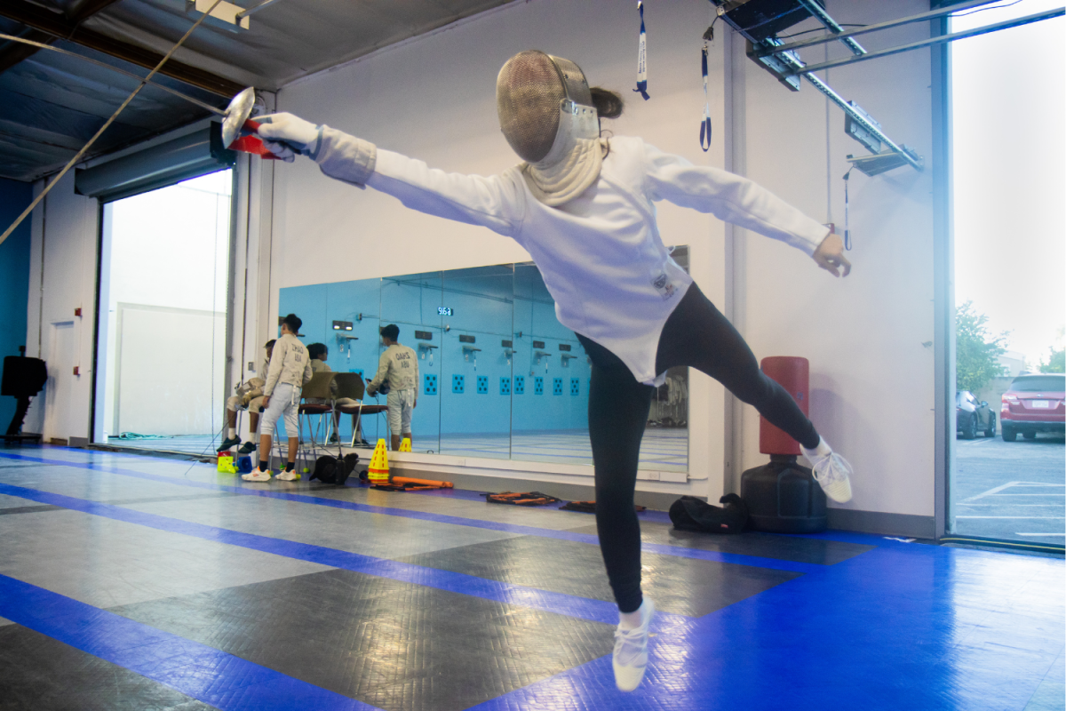 Senior Grace Ker jumps up to strike her opponent during practice. Photo by Gary Pan.