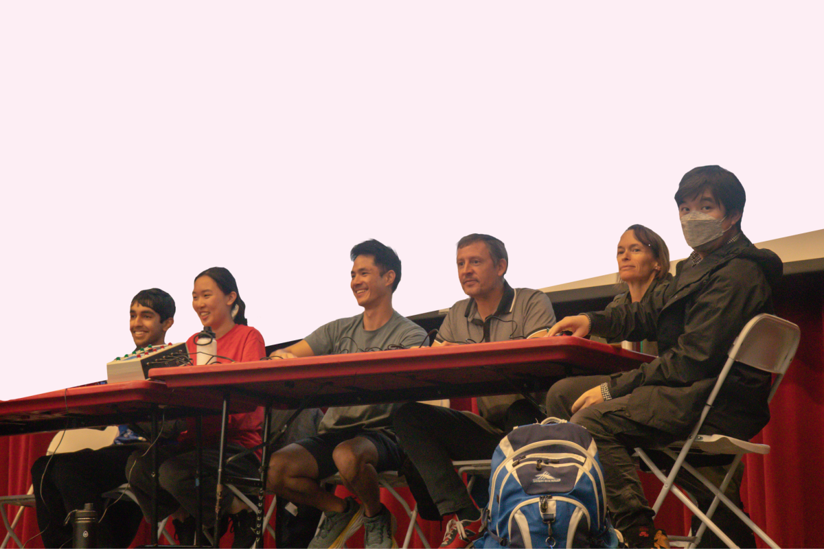 Junior Sohil Rathi, senior Selena Yang, chemistry teacher Lester Leung, calculus teacher Jeremy Dybdahl, biology teacher Nicole Della Santina and physics teacher Thanh Nguyen compete to answer questions in the theater.